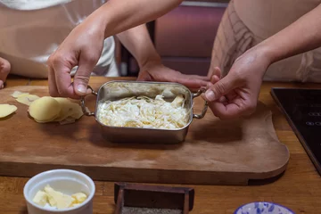 Foto op Canvas process of cooking baked gratin potatoes hands rustic decor © Angelina Zinovieva