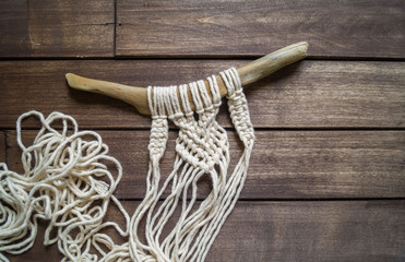 Weaving macrame. Favorite hobby.Weaving a natural cord on a branch