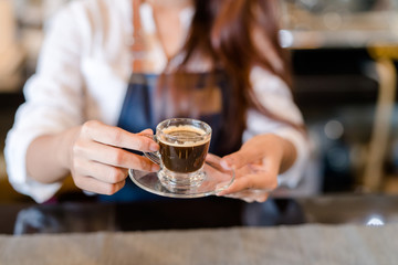 Professional woman Barista preparing coffee at front counter serving coffee cup to customer occupation, part-time,job or owner business working woman happy selling and making drink beverage