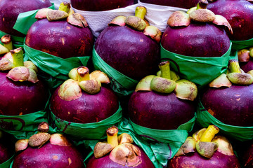 Fresh mangosteen or purple mangosteen on fresh market. Fruit originates from Southeast Asia such as rambutan.