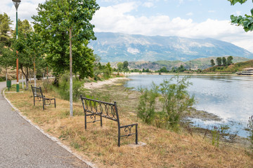 Empty wooden park bench overlooking Viroi lake.