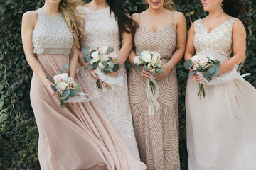 bridesmaids holding wedding bouquets, tan dresses - obrazy, fototapety, plakaty