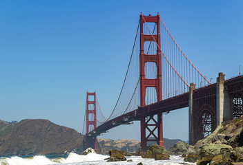 Golden Gate Bridge in the city of San Francisco, California, USA, the most famous and recognizable bridge in the world, a view from an unusual angle in clear sunny weather against a blue sky, one of