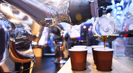 Automatic technology in beverage shop, artificial intelligence, robotic arm serving in coffee shop.