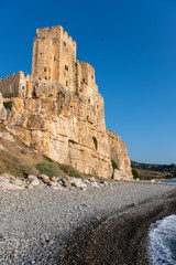 Fototapeta na wymiar Roseto Capo Spulico, Cosenza district, Ionian Coast, Calabria, Italy - View of the federiciano castle placed on a rock from the beach