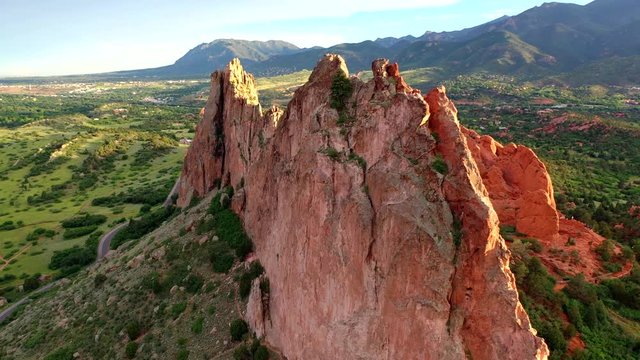 Aerial, drone shot, panning around the famous, red sandstone mountains, at the Garden of the Gods park, on a sunny evening, in Colorado springs, USA