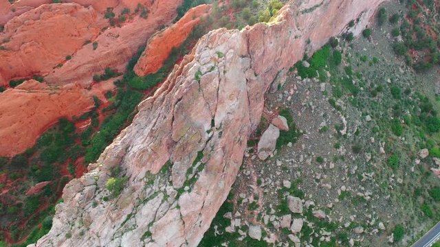 Aerial, drone shot, panning over the famous, red sandstone mountains, at the Garden of the Gods park, on a sunny evening, in Colorado springs, USA