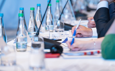 close up of business people taking notes