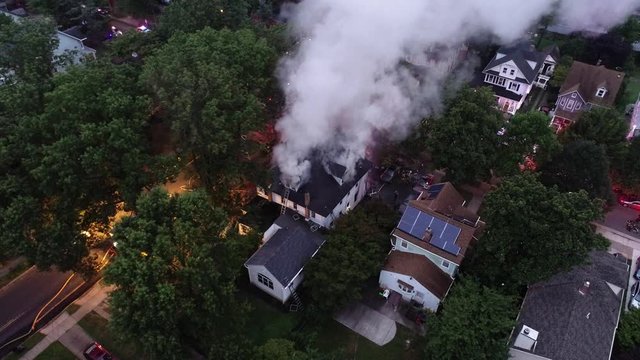 Aerial View of Fire Trucks and Apparatus battling a House Fire