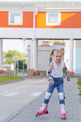 little girl rides inline skates
