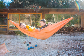 Kids are played in a hammock.