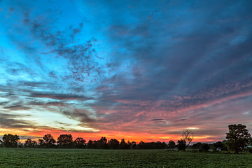 Rural Awakening - A planted field is topped by a beautiful sky at sunrise in the rural Midwest of America.