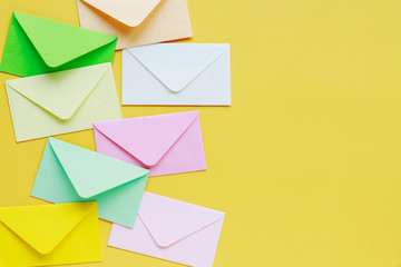 Colorful envelopes on yellow background