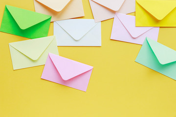 Colorful envelopes on yellow background