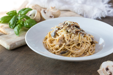 Mushroom Spaghetti Pasta and cream sauce on table, top view. Homemade italian pasta with champignon mushroom