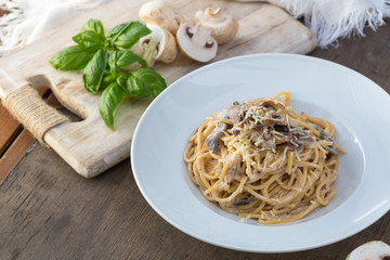 Mushroom Spaghetti Pasta and cream sauce on table, top view. Homemade italian pasta with champignon mushroom