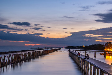 Fototapeta premium Beautiful of The walkway bridge in evening at Bang Khun Thian sea view, Bang Khun Thian, Bangkok.