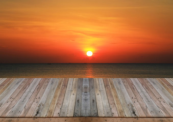 Wood table top on sunset background