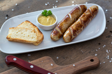 Grilled sausages. Closeup of sausage on the grill. Home-made Sausages. Bavarian sausages