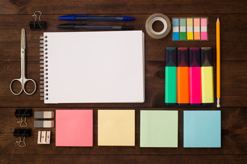 Back to school flat lay. School supplies on brown wooden table.