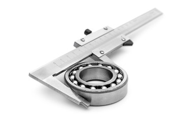 Calipers with metal bearing on white.