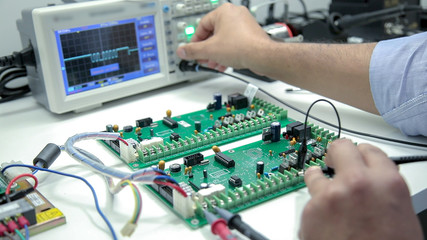 manual electronics soldering and oscilloscope testing - obrazy, fototapety, plakaty