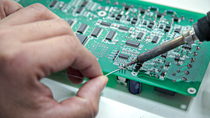 manual electronics soldering and oscilloscope testing