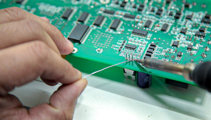 manual electronics soldering and oscilloscope testing