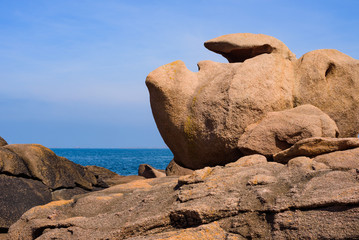 Seascape with huge pink granite boulders near Plumanach. The coast of pink granite is a unique place in Brittany. France