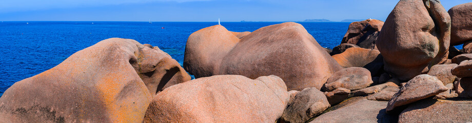 Fototapeta na wymiar Sea Panoramic Landscape with huge pink granite boulders near Plumanach. The coast of pink granite is a unique place in Brittany. France