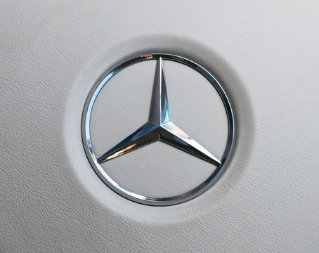 Imatra, Finland, September 3 2017: Close up view of a Mercedes-Benz logo on white leather steering wheel. Modern car interior details.