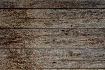 Close-up of wall made of wooden planks. Old dark brown wooden wall background texture.