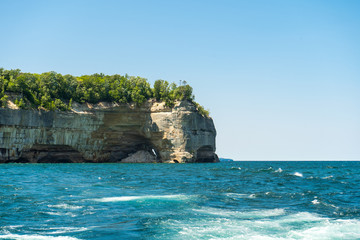Naklejka premium view from the lake at beautiful rocky cliff and forest , Pictured Rocks National Lakeshore