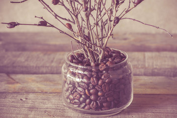 Roasted coffee beans background macro photo, selective focus for copy space.Sack with roasted coffee beans on dark background, close up view