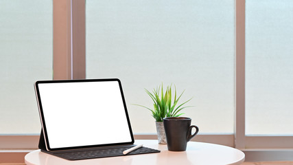 Mockup digital tablet, pencil and coffee on table.