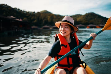 Foto op Canvas Asian girl is kayaking at Kanchanaburi, Thailand. © tuckraider