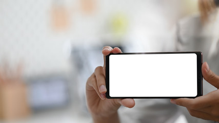 Young woman's showing empty screen of smartphone.