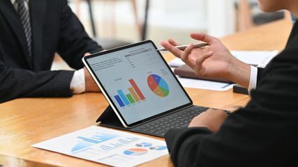 Two businessman meeting and consult with digital portable computer on table.