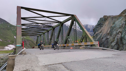 A bike rider crossing the zojila pass at an elevation of 11,000 ft. at Jammu and Kashmir. Way...