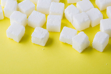 Sugar cube on yellow background