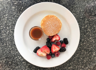 Close up of pan cake with mix berry in the white dish