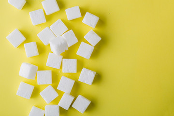 Top view of sugar cube on yellow background