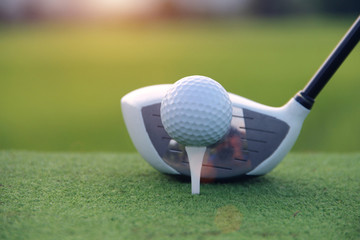 Golf ball and golf club in beautiful golf course at sunset background. Golf ball on green in golf course at Thailand
