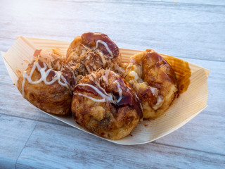 Takoyaki - a Japanese snack of savory ball-shaped cake made from wheat batter cooked on a specially shaped griddle