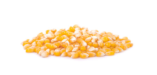 Pile of yellow corn kernels isolated over the white background