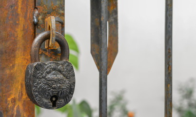 An antique lock on a rusted handle