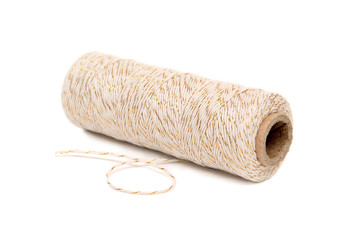 spool of twine with gold