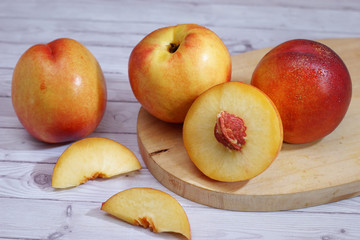 Fototapeta na wymiar fresh nectarine fruit also as known peach fruit served on wood texture background