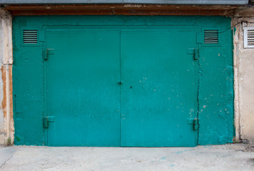 old metal door to the car garage