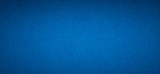 blue flat color paper sheet with light accent in the middle, vignetted background